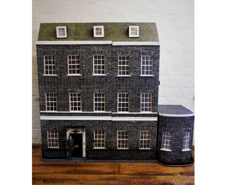 A dolls house modelled as an accurate representation of 10 Downing Street, the exterior with black brick effect facade, remov