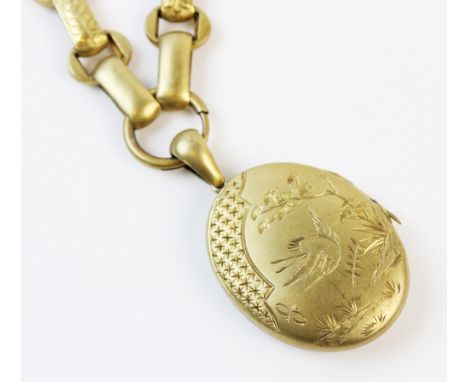 A Victorian aesthetic movement locket and chain, the oval locket engraved with a crane and other aesthetic motifs to one side
