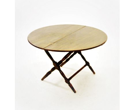 A 19th century mahogany coaching table, the circular folding top with inset brass butterfly hinges, raised upon ring incised 