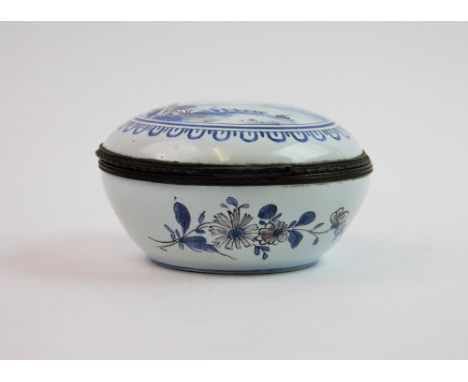 A 19th century Dutch Delft hinged box and cover,  landscape to the cover, in leaf border surround, hinged cover with wrought 