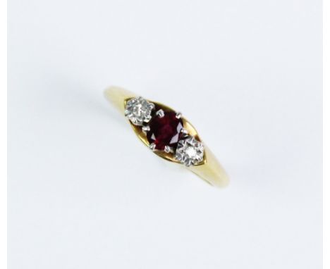 A ruby and diamond three-stone ring, the central oval ruby measuring 5mm x 4mm, flanked to each side by an illusion set diamo