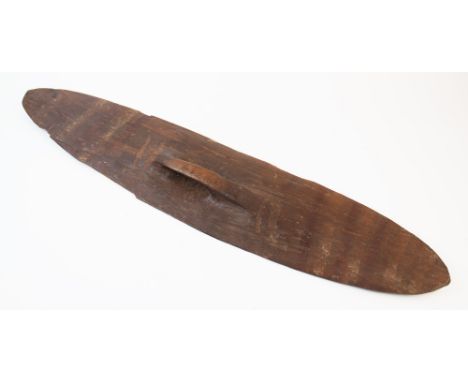 An Australian Aboriginal Wunda shield with white pipe clay decoration and carved handle, 77cm long For condition information 