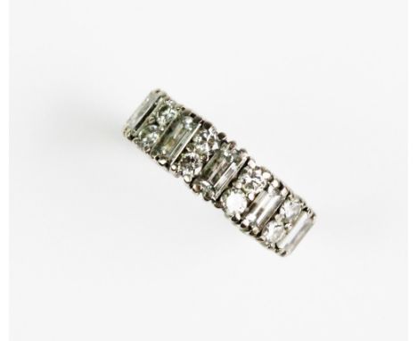 A diamond set 18ct gold ring, comprising five baguette cut diamonds each interspersed with two brilliant cut diamonds, all cl