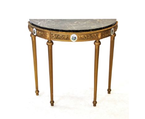 A gilt French style marble top console table, 20th century, the demi lune marble top supported on fluted tapering legs of cyl