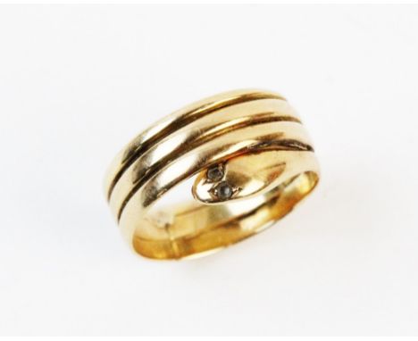 A diamond set serpent ring, the stylized snake form ring with two small diamonds set to eyes, plain polished unmarked yellow 