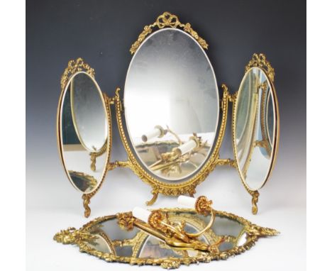 A gilt metal oval wall mirror, with foliate and bow surround enclosing a mirror plate, 62cm high, with a 19th century style g