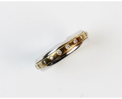 A diamond set ring, comprising twenty small round brilliant cut diamonds set to a brushed yellow metal band, set to a white m