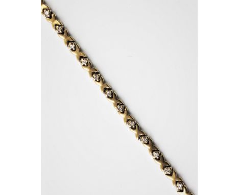 A diamond set yellow metal line bracelet, comprising 28 claw set brilliant cut diamonds interspersed with cross shaped spacer