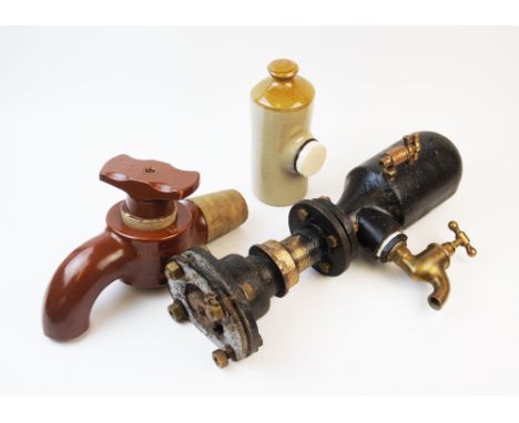 An early 20th century Wells iron paraffin gas lamp, 73cm, of domed form, along with an industrial iron and brass tap fitting,