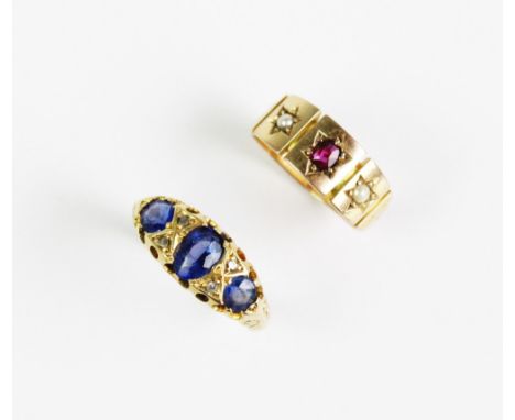 An Edwardian sapphire and diamond set 18ct gold ring, comprising three sapphires interspersed by diamond chips, all set in ye