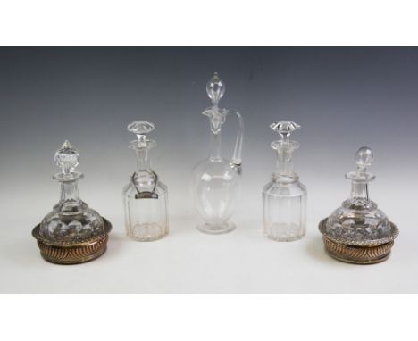 A pair of clear glass decanters, each of faceted 'mallet' form and with hexagonal stopper, one with 18th century silver decan