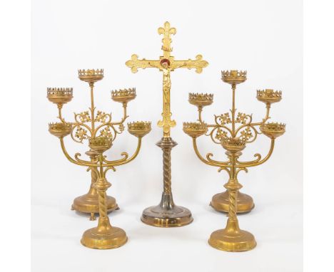 An assembled collection of church items, 2 pairs of candlesticks with 3 points of light, and a large crucifix. Decorated with