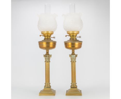 A pair of Oil lamps made of copper with glass lamp shades and ionic pillars. 19th century. Made in England. (76 x 19 cm)