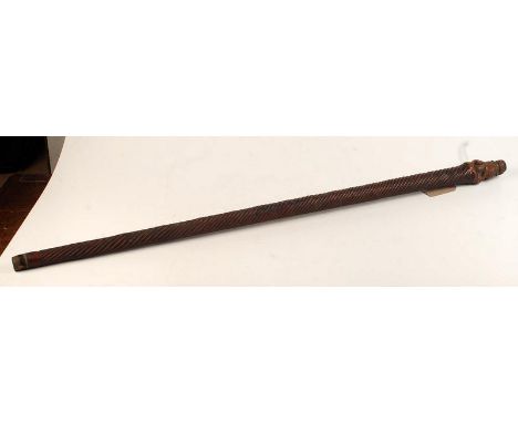 A Chinese bamboo walking stick with temple lion carved finial over barrel fluting.