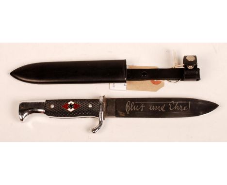 A Hitler Youth knife, the handle enamelled with swastikas, the blade engraved and with its original metal scabbard. Condition