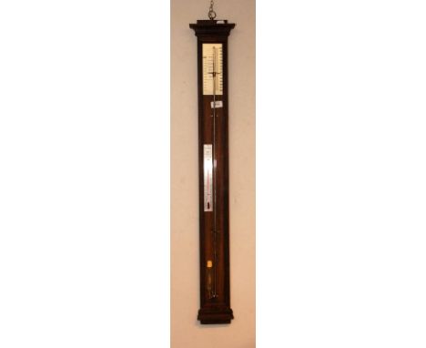 A stick barometer with a stainless steel scales on an oak mount.