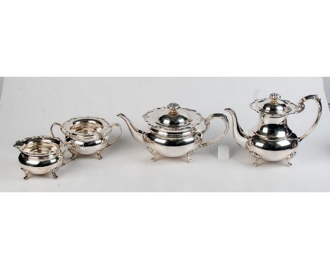 A modern four piece circular section silver tea service, each piece of bulbous form with flared, decorative rims, by Cooper B