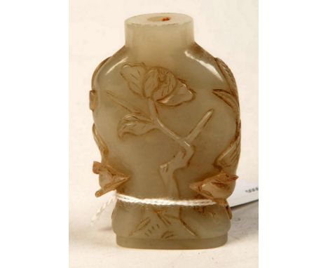 A Chinese jade snuff bottle carved with a phoenix.