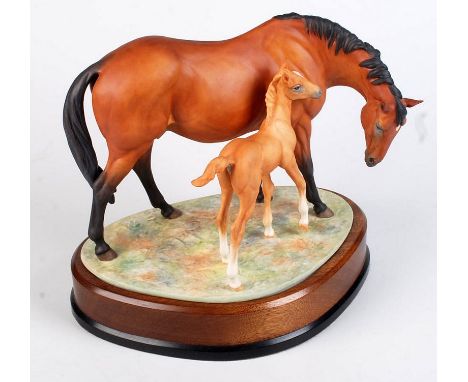 A Royal Worcester Prince's Grace and Foal modelled by Doris Lindner. No 504. Width of hardwood base 25.6cm. Condition Report: