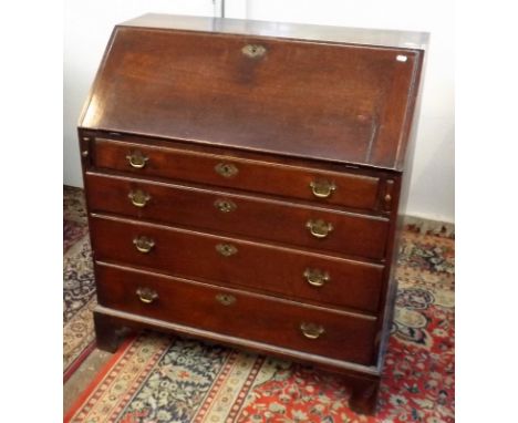 A George III oak bureau with a slope front above four long graduated drawers on bracket feet, width 91cm,