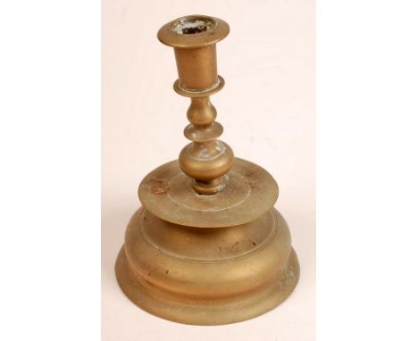 An antique Dutch brass candlestick with a circular drip tray on bell shaped base. Height 20cm, together with a continental ce