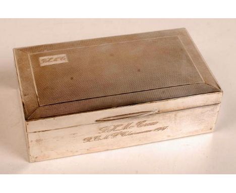 A George VI silver cigarette box of rectangular form with engine turned lid, twice engraved with initials and inscription, by