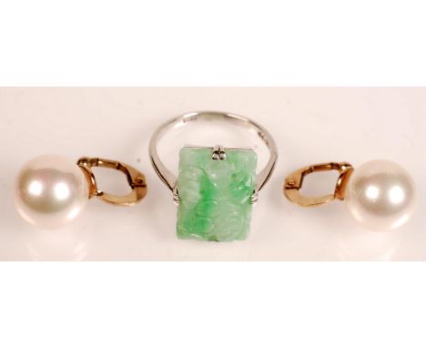 A 9ct. gold ring set with a carved jade panel together with a pair of gold mounted 'pearl' ear clips. 