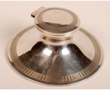 An engine turned silver capstan inkwell, Birmingham, 1913, by A. & J. Zimmerman Ltd., diameter 14.3cm.