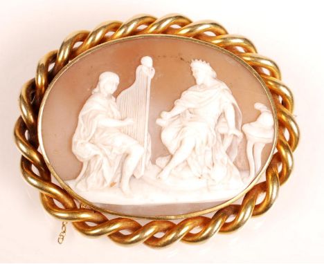A 19th century Italian carved shell cameo depicting Saul listening to David play the harp, gold brooch mount with rope twist 