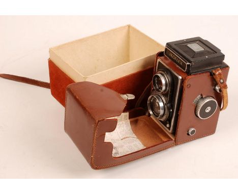 A Zeiss Ikon Ikoflex twin lens reflex camera in a brown leather case with its original box.