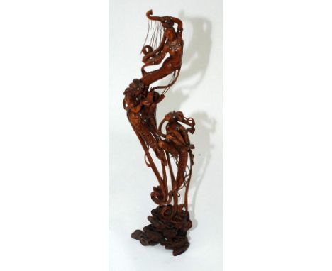 A Chinese Republic carved hardwood figure of three female musicians set with pearls, signed to a tablet. Height including har