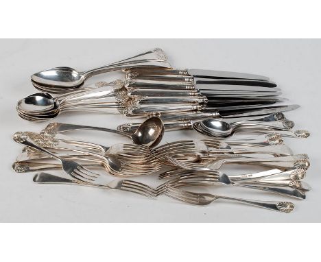 A silver Old English Shell pattern suite of flatware comprising: 12 knives, 12 forks, 11 dessert spoons, 12 dessert forks, 5 