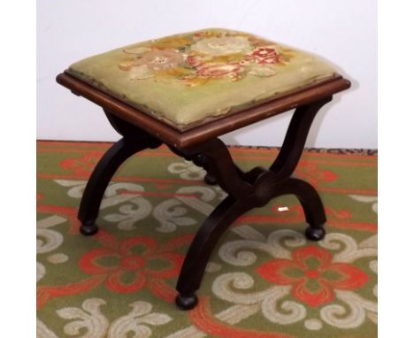 A mahogany stool with "X" supports and needlework seats.