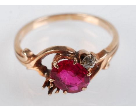 A gold ring set with an oval ruby and a small diamond, the companion stone missing, 2.1g. Condition Report: Size K, 16mm
