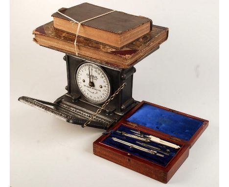 A Jaraso 'Weighing Machine' with cast iron case. The scale is read via a folding mirror. Together with a part drawing set and