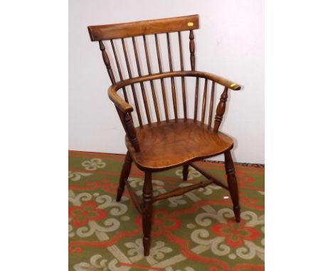 A 19th century Windsor low comb back armchair with horizontal crest rail.