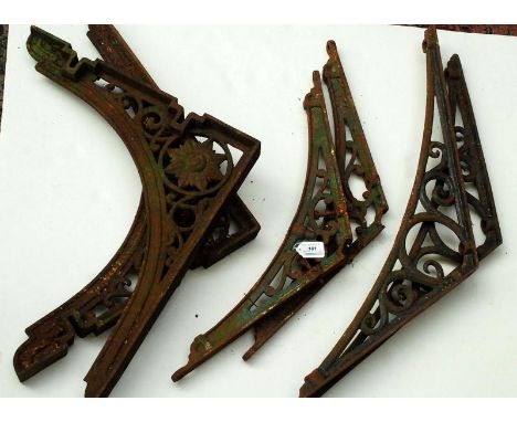 Six cast architectural roofing brackets.