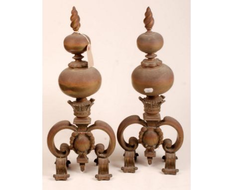 A pair of 19th century brass fire dogs, each with a flambeau finial above two graduated  spheres and a castellated coronet. H