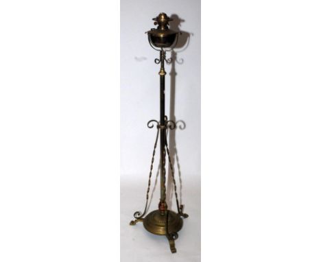 A Victorian brass standard oil lamp with tripod base.