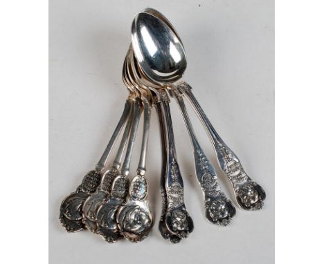 A set of four 'The British Bulldog Club' prize spoons, each with a bulldog mask finial, together with a set of four 'Manchest