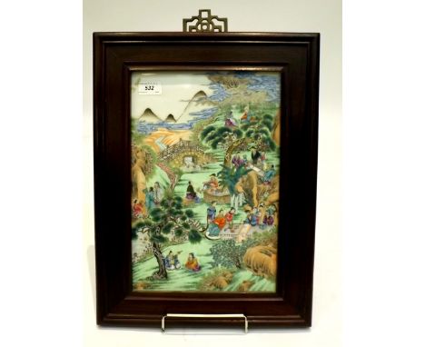 A Chinese porcelain tile, richly enamelled in famille rose style with a gathering of numerous figures seated in groups, enjoy