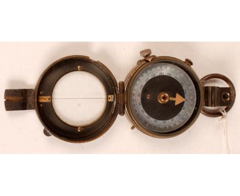 A military brass prismatic field compass by F. Garton & Co. London, dated 1915, with a mother-of-pearl dial.