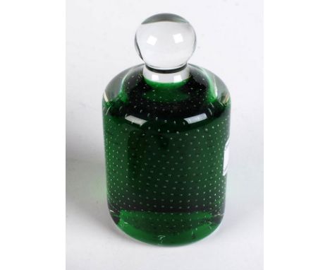 An English glass cylindrical paperweight, the clear metal encasing a green mound covered with small bubbles, ball finial, hei