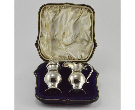 An Edwardian baluster silver sugar sifter and cream jug, maker Elkington &amp; Co, London 1908, approximate weight all in 285