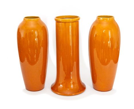 A new pair of Bretby Art Pottery baluster vases with yellow glaze decoration and a similarly decorated vase with splayed base