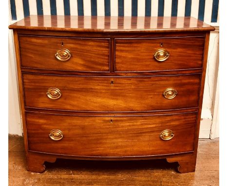 A 19th Century mahogany bow fronted chest of drawers, two short and three long drawers with brass handles and keyholes, on ca