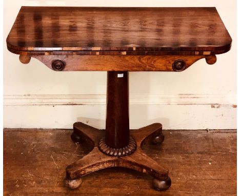 A George IV rosewood card table, circa 1820, rounded rectangular hinge fold over twist top enclosing inlaid card playing surf