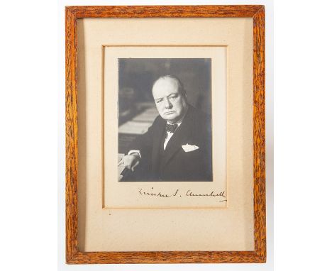 Winston Churchill (1874-1965), photographic war-time portrait by Walter Stoneman, bearing signature/autograph in black ink to