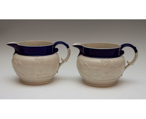 Two large Chetham and Woolley feldspathic stoneware jugs with blue rims, circa 1810. Each is decorated with the same hunting 