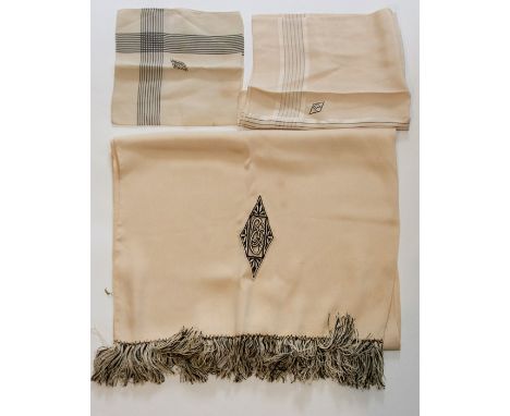 A 1920's silk long fringed gents evening scarf, in deep cream silk, with an Art Deco emblem by A Sulka &amp; Co Ltd; two silk